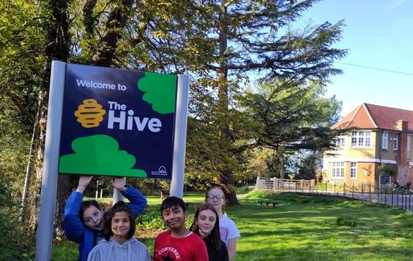 Greenleaf pupils standing at The Hive entrance sign