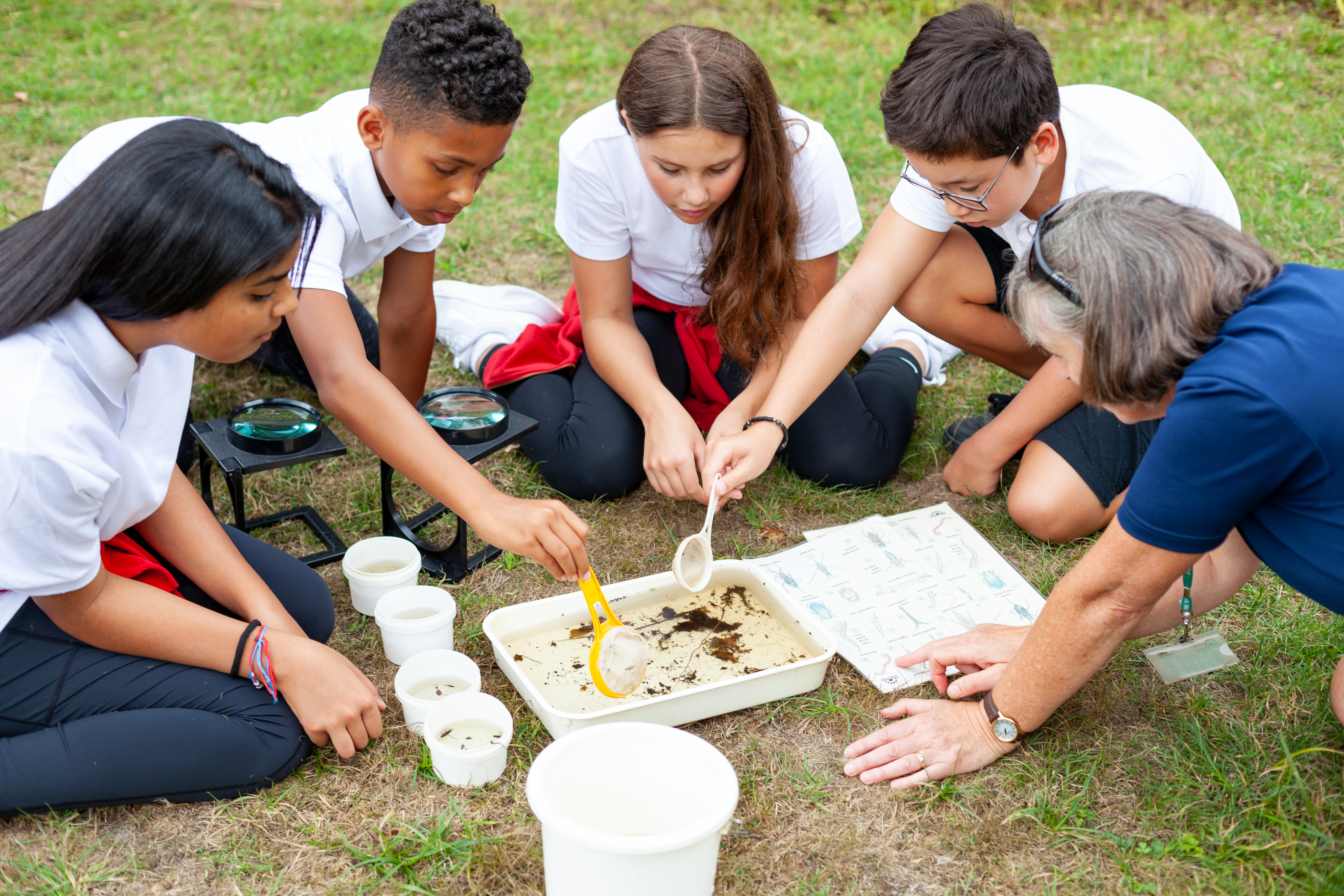 Children exploring the soil trays gathered about