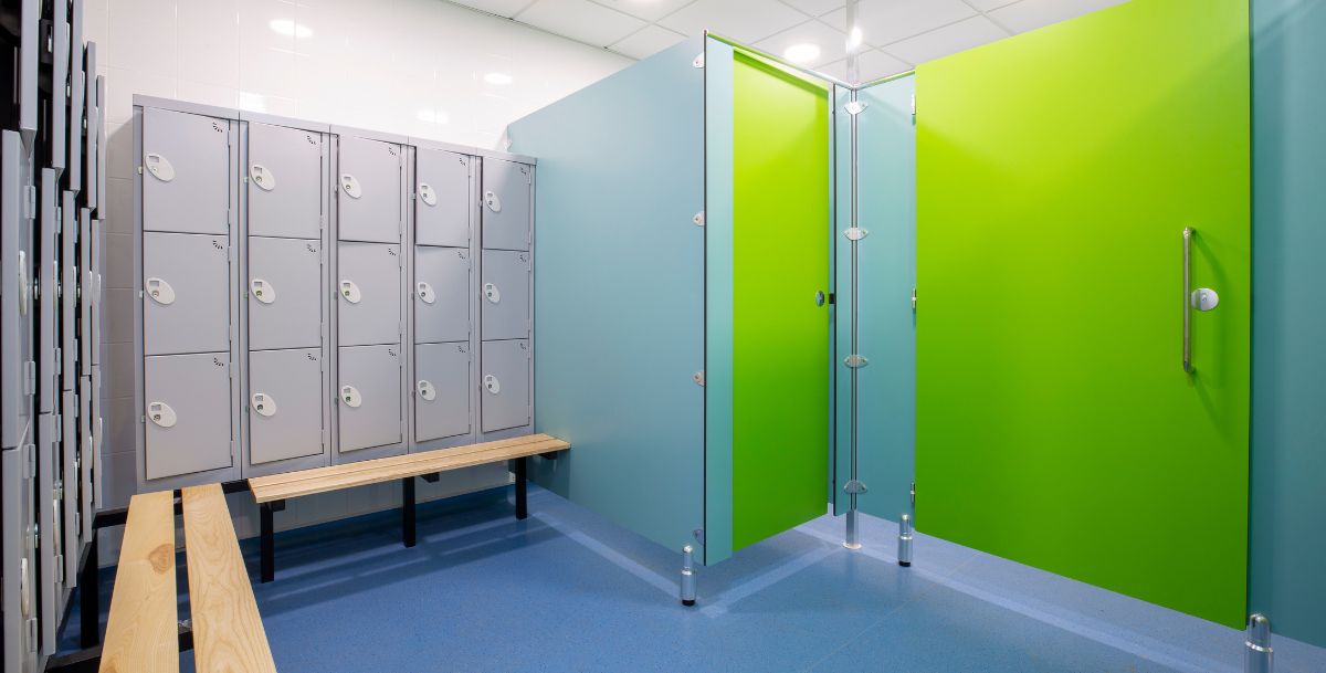 Communal shower doors with lockers outside in a bright green and grey colour way
